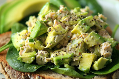 Nutritious and flavorful sandwich featuring creamy avocado chicken salad made with shredded chicken, mashed avocado, and spices, served on hearty whole grain bread.