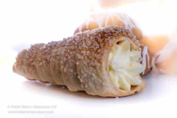 Pastry cone with cream and cherry